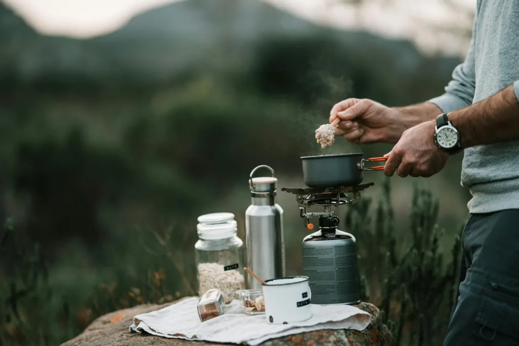 Camping cooking gear and stove setup outdoors