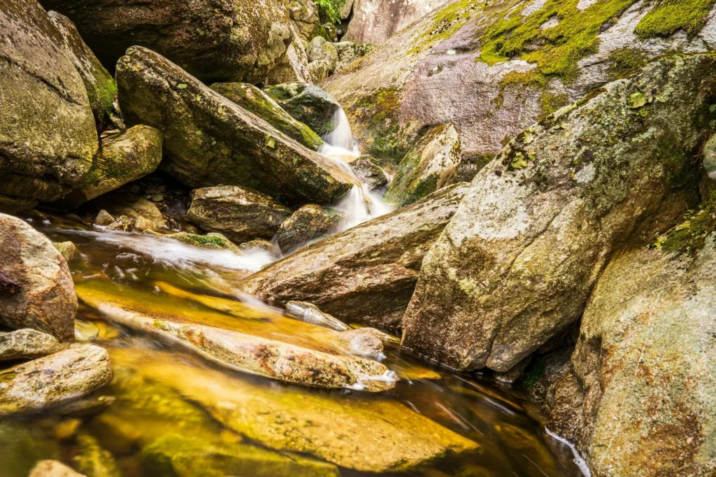 Clear mountain stream flowing over rocks on a UK hike
