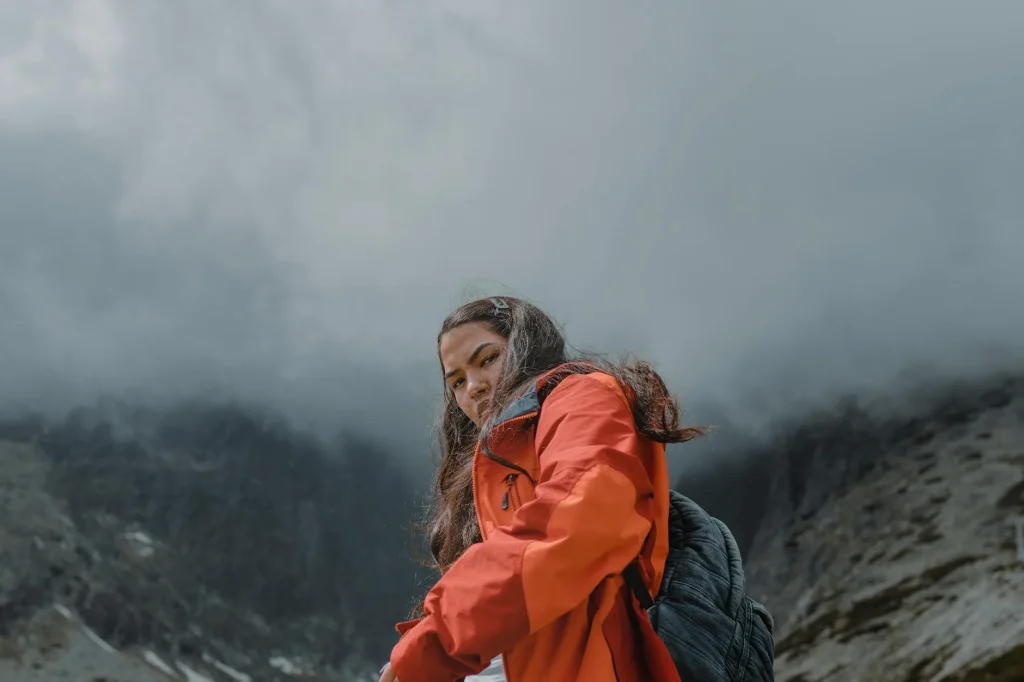 Hiker on a UK mountain wearing layered outdoor clothing