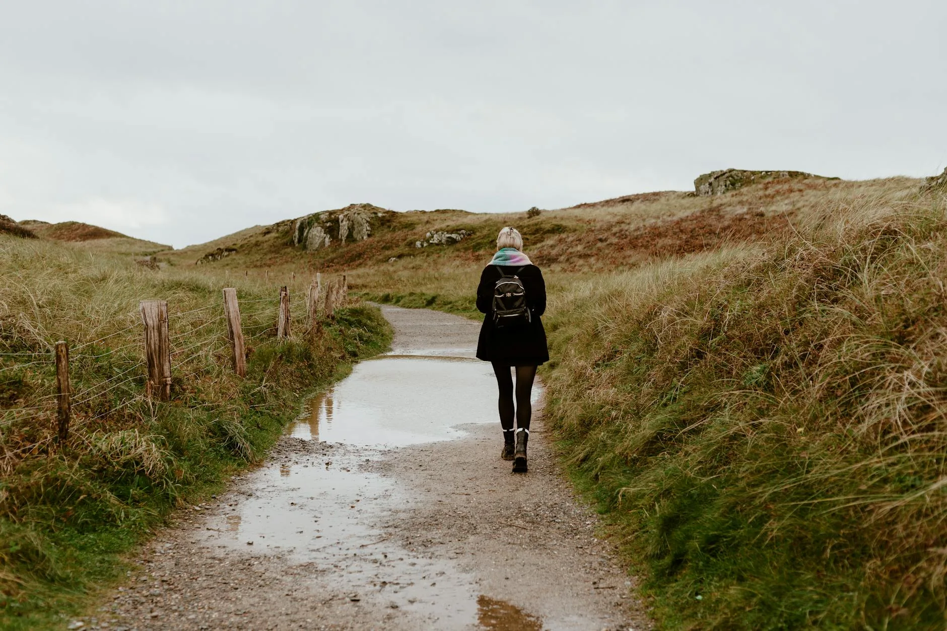 Hiker walking a mountain trail with a packed rucksack