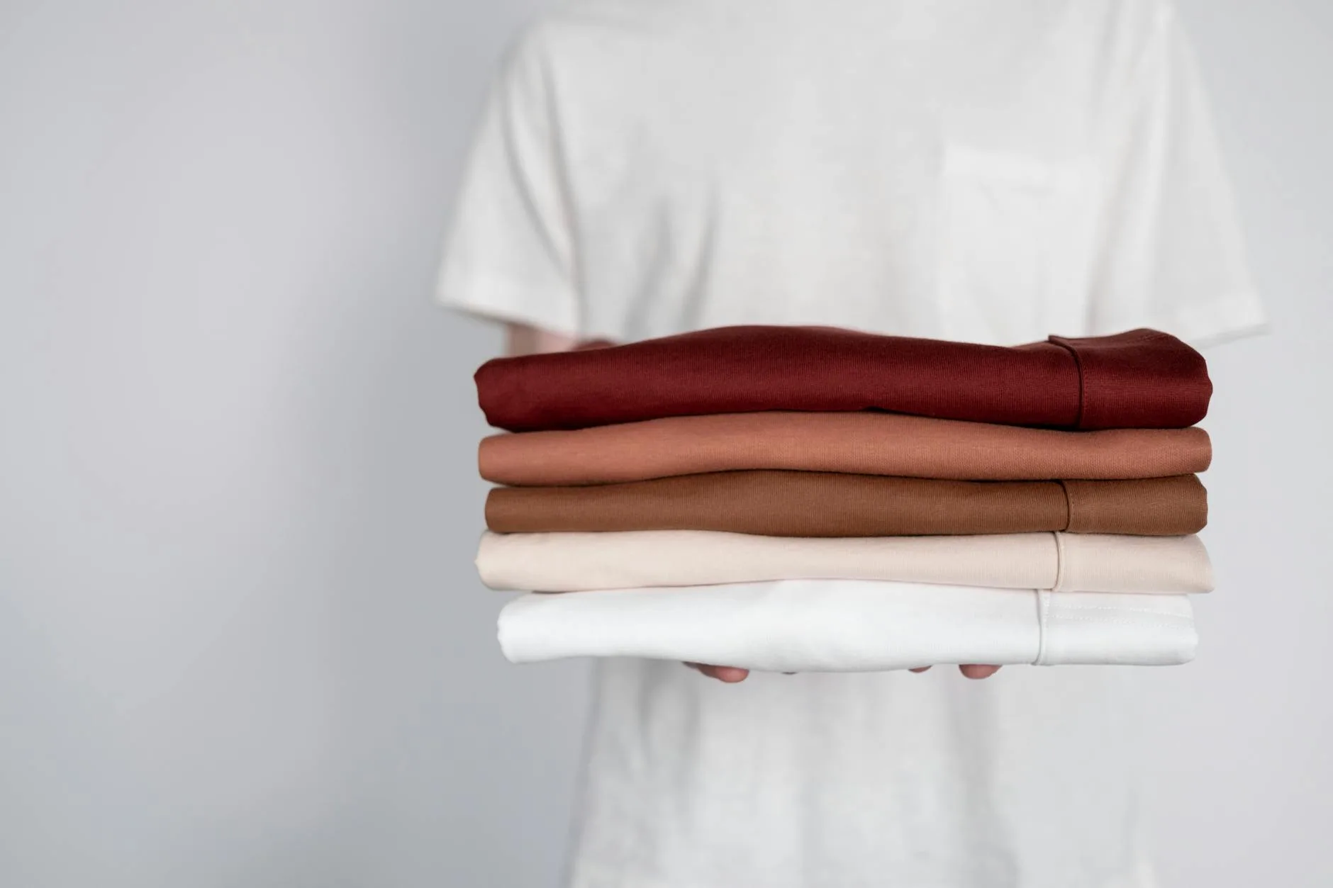 Folded merino wool base layers stacked neatly