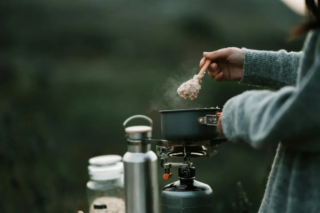 Cooking a one-pot meal on a camping stove outdoors