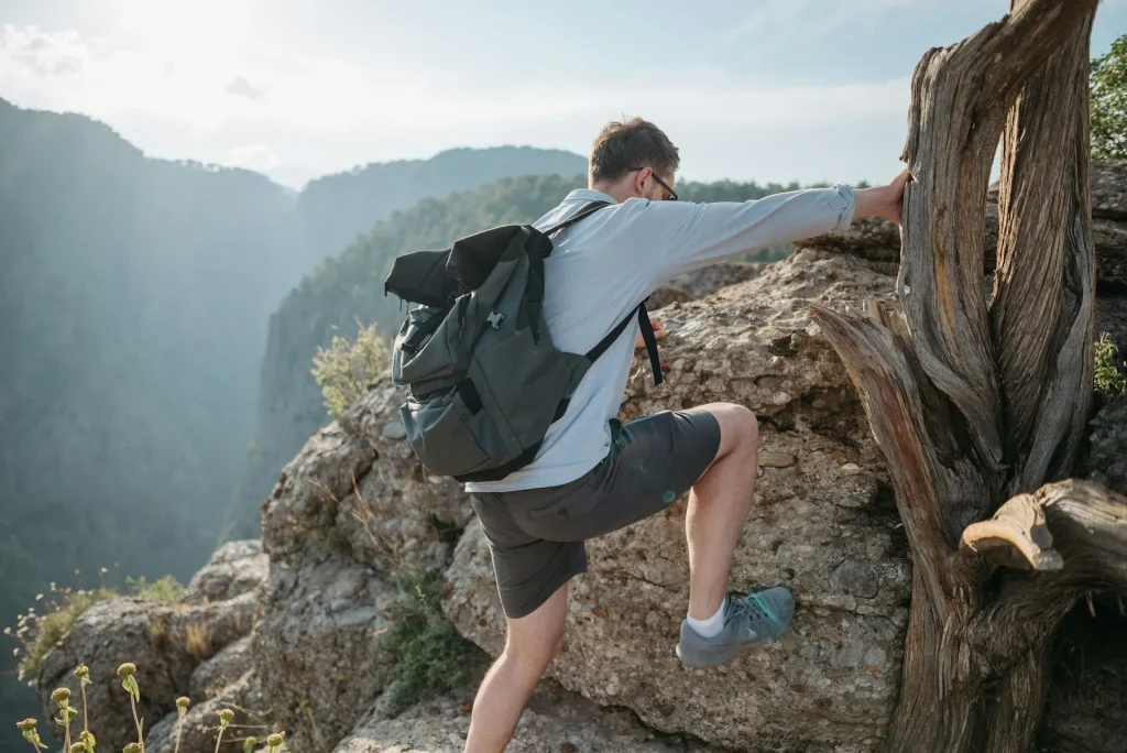 Hikers with day packs exploring outdoors on a sunny day