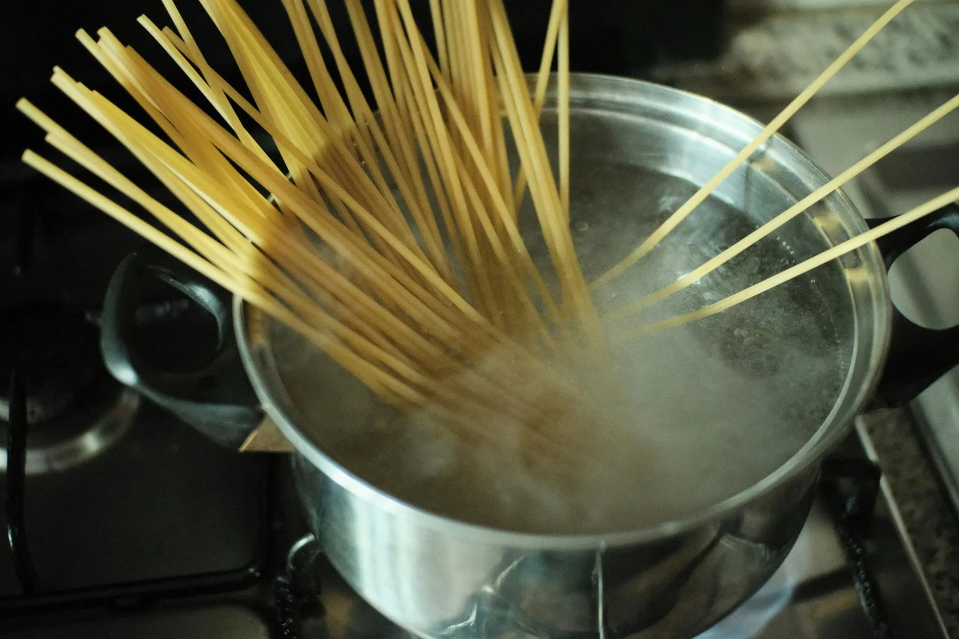 Pasta cooking in a pot over a camping stove
