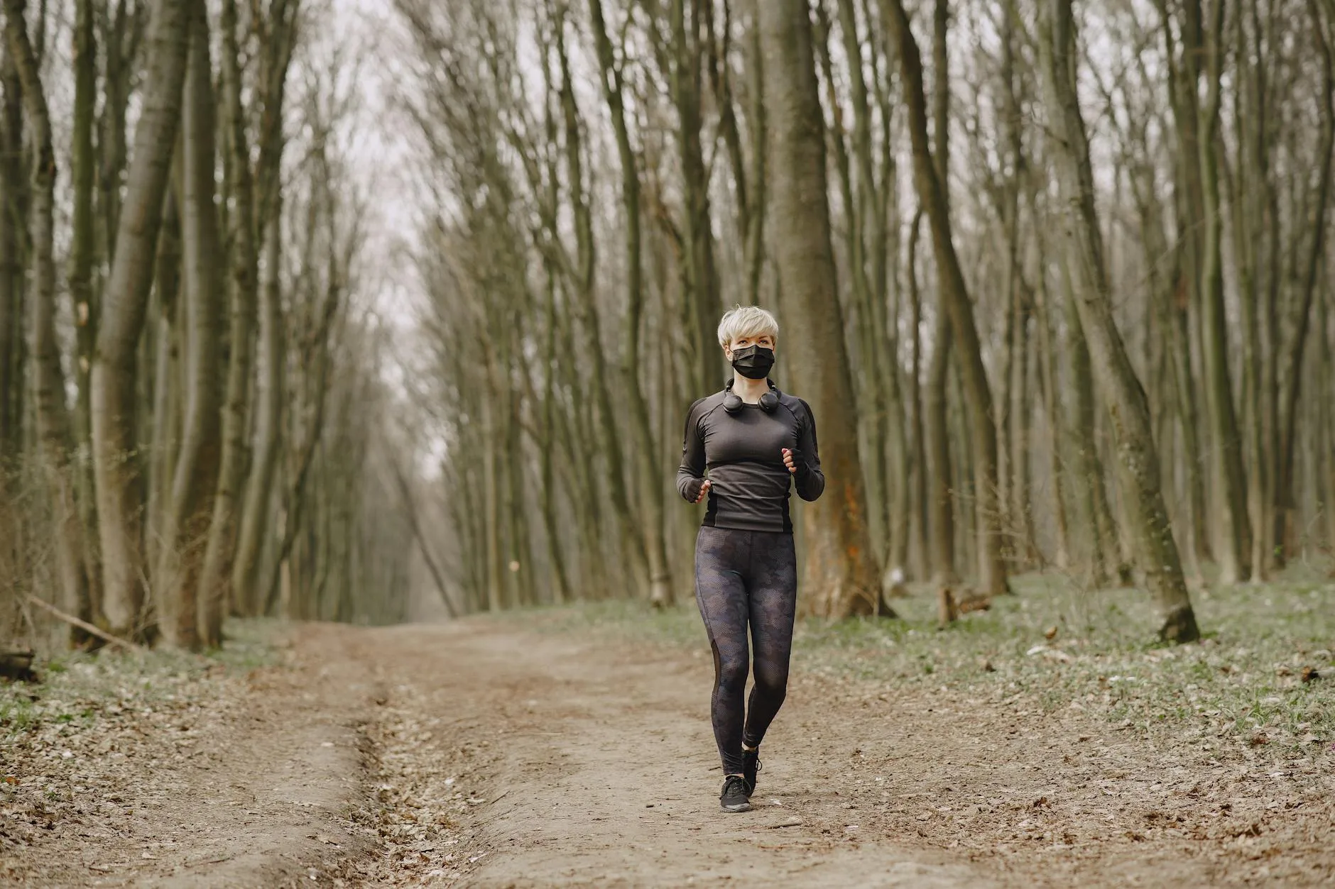 Person running on an outdoor trail in morning light