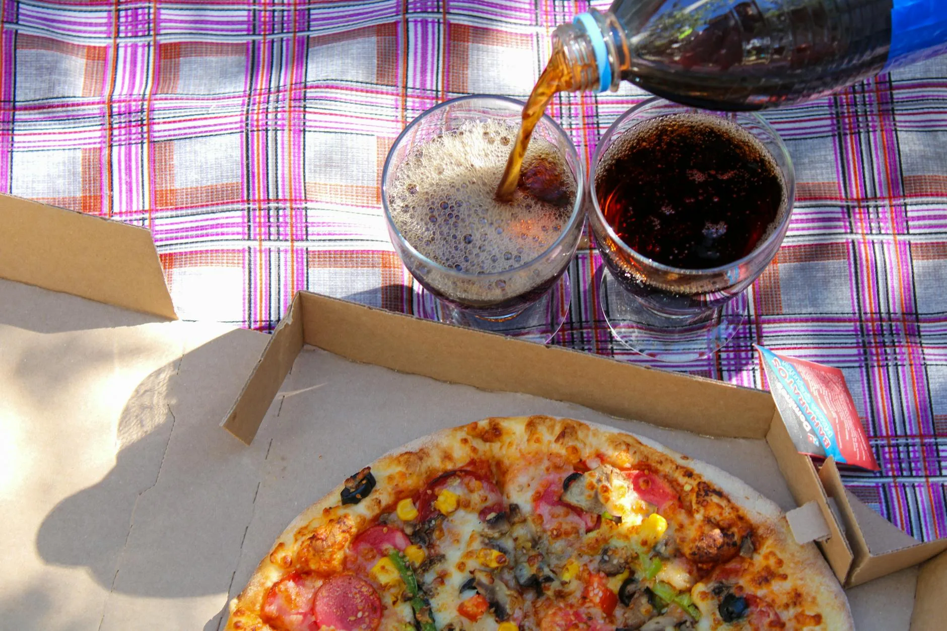 Cold drinks and food packed for an outdoor picnic