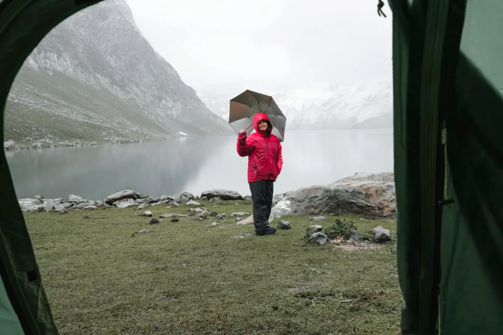 Tent pitched in rainy weather at a campsite with dark storm clouds