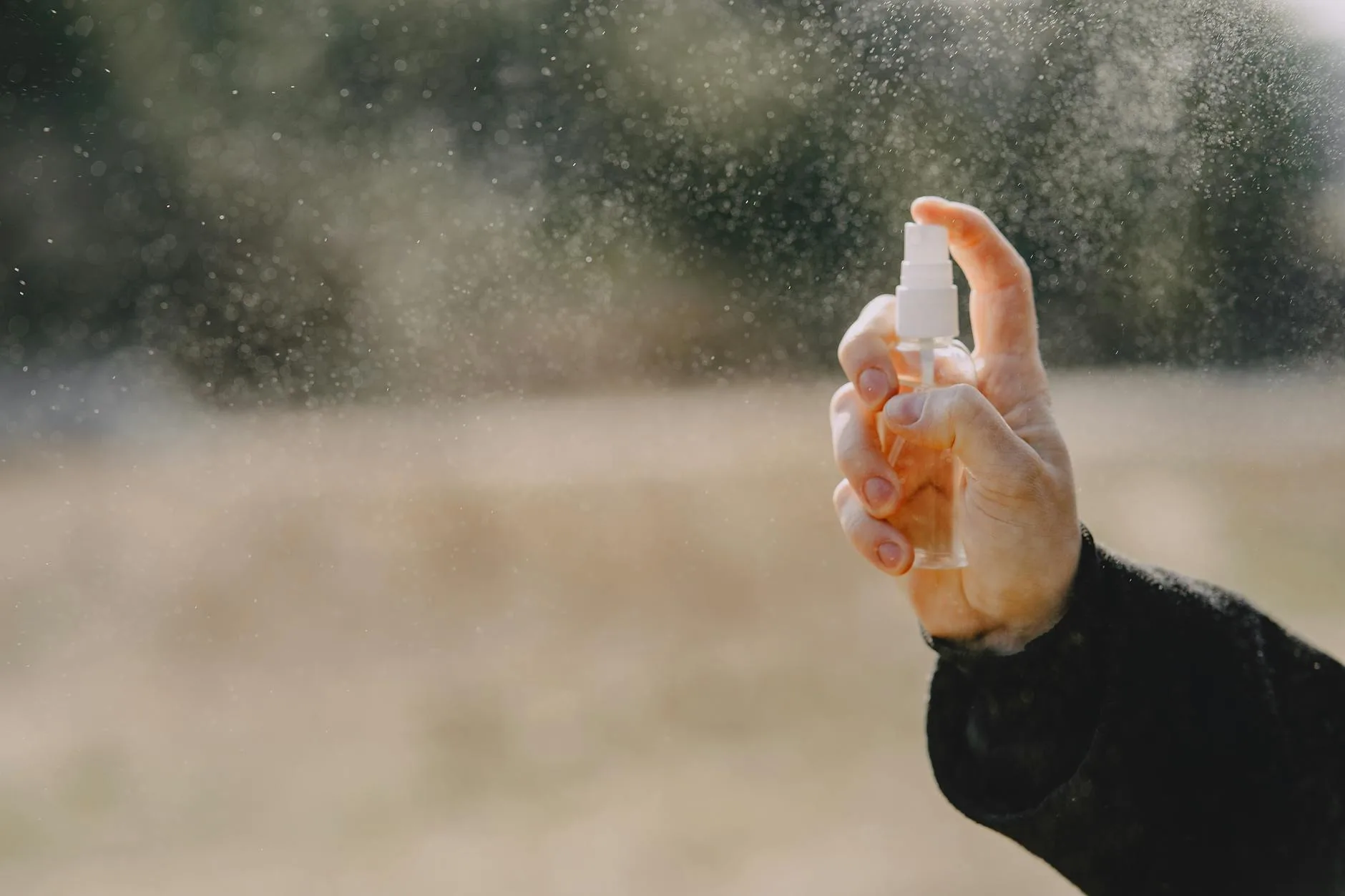 Applying waterproofing spray to an outdoor jacket