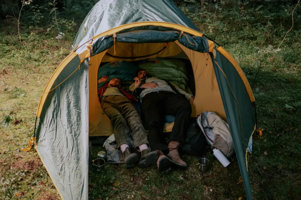 Colourful sleeping bag laid out on a tent floor for camping