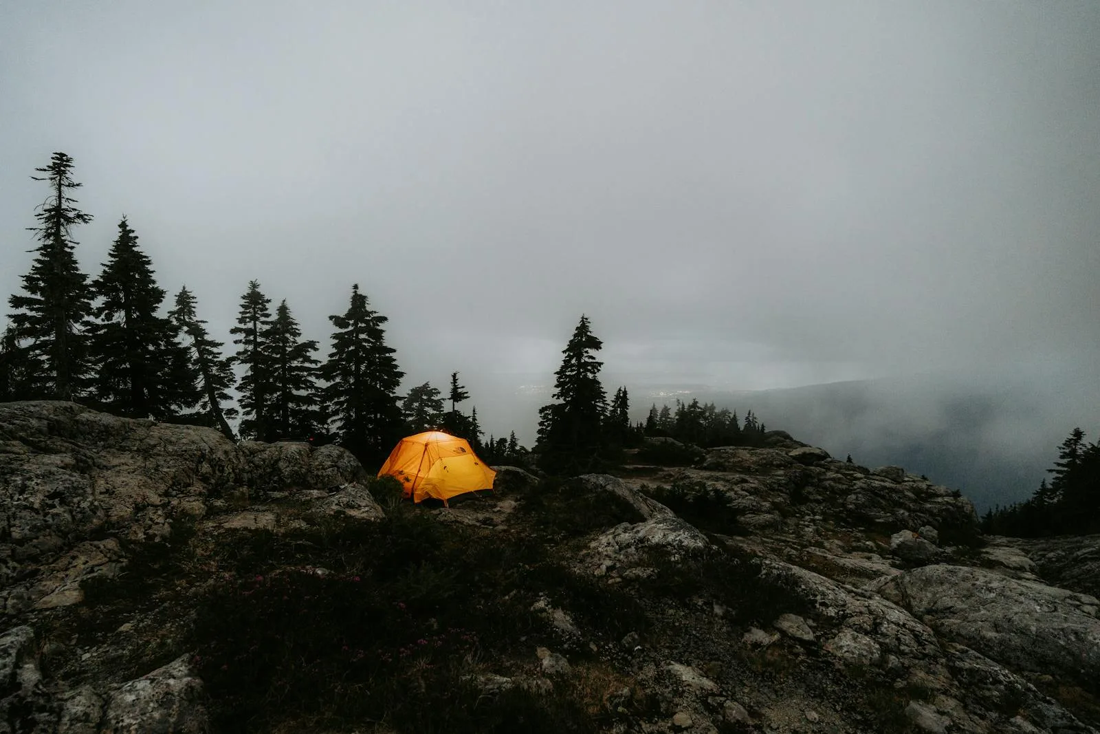 Tent pitched at a foggy mountain campsite demonstrating season rating conditions