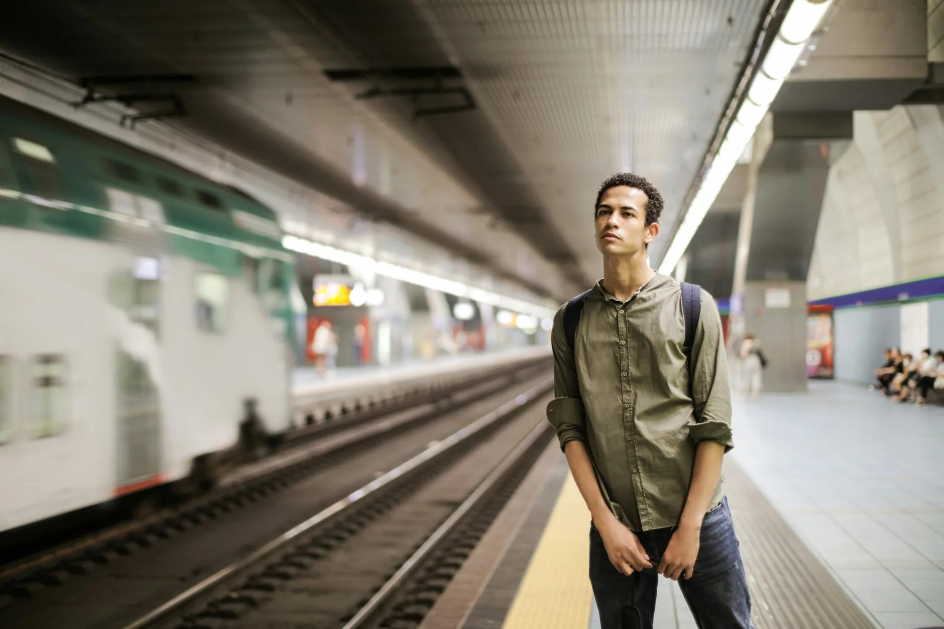 Traveller carrying a backpack through a busy train station