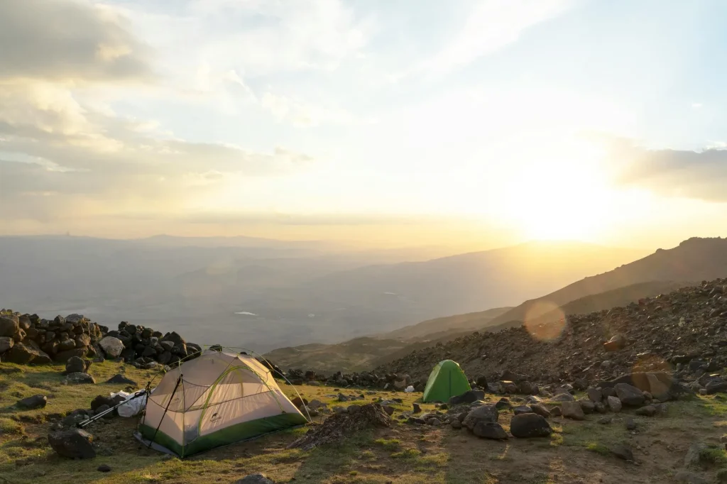 Lightweight hiking tent pitched on a mountain with scenic landscape