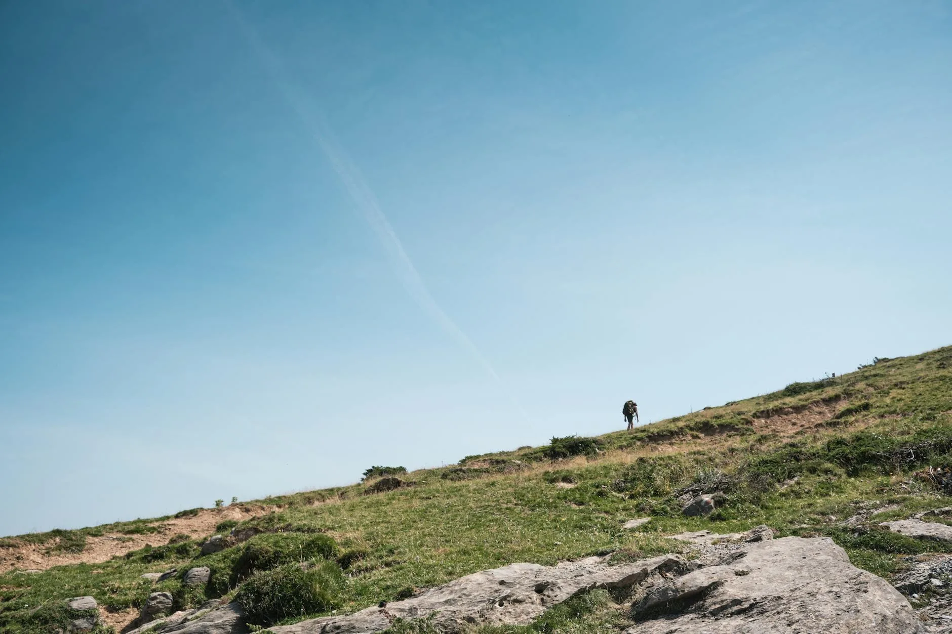 Hiker on a mountain trail path in the UK countryside