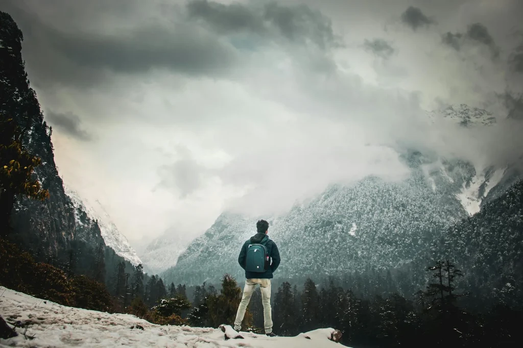 Hiker wearing a waterproof rucksack on a rainy mountain trail