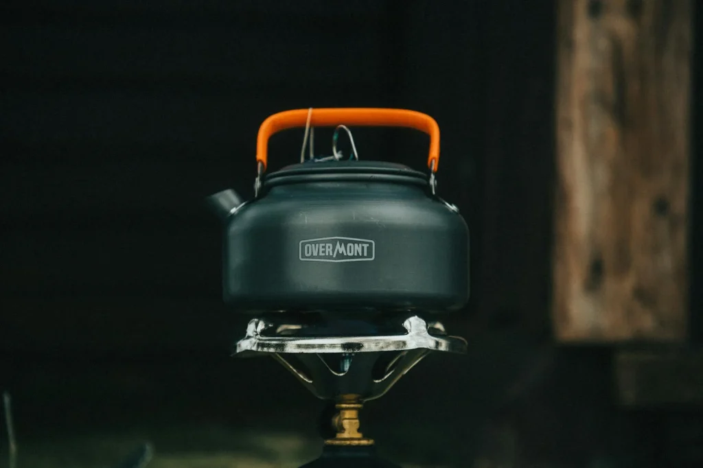 Camping stove with a pot cooking outdoors