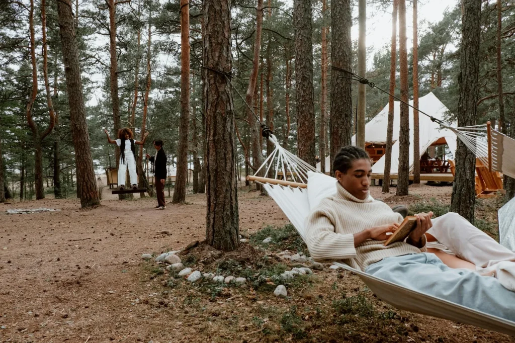 Camping hammock strung between trees in a forest