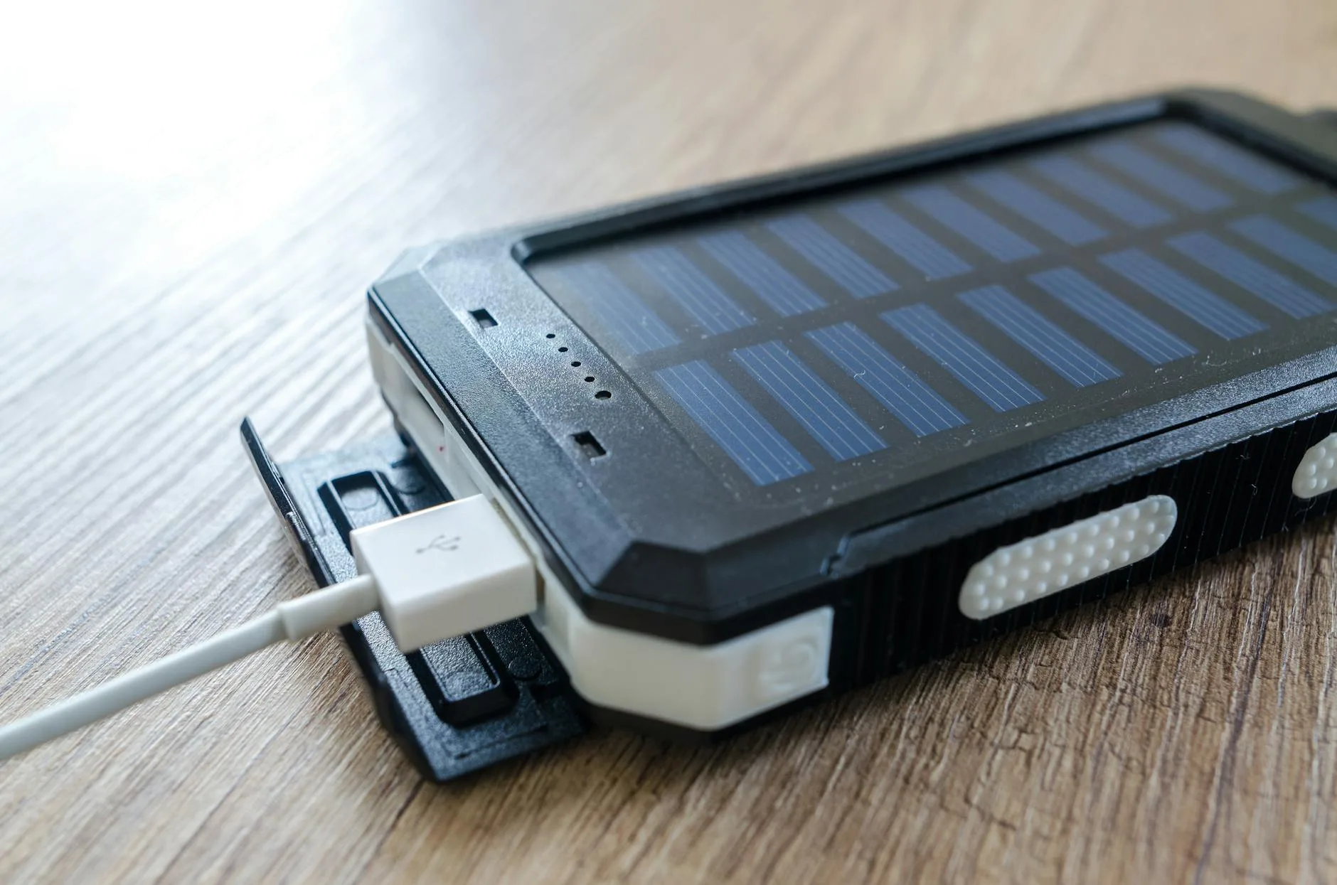 Portable power bank charging a device via USB cable