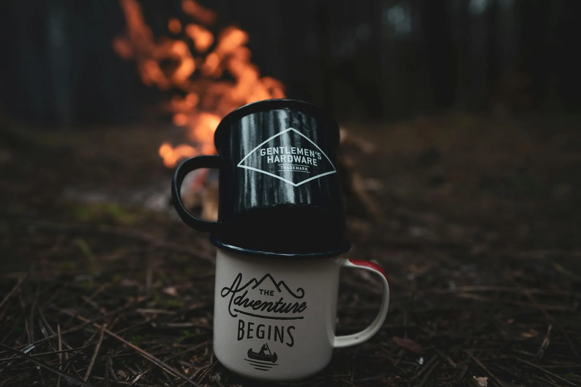 Hot drink steaming by a campfire in cold weather