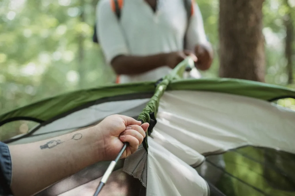 Tent pitched at a green campsite on a clear morning