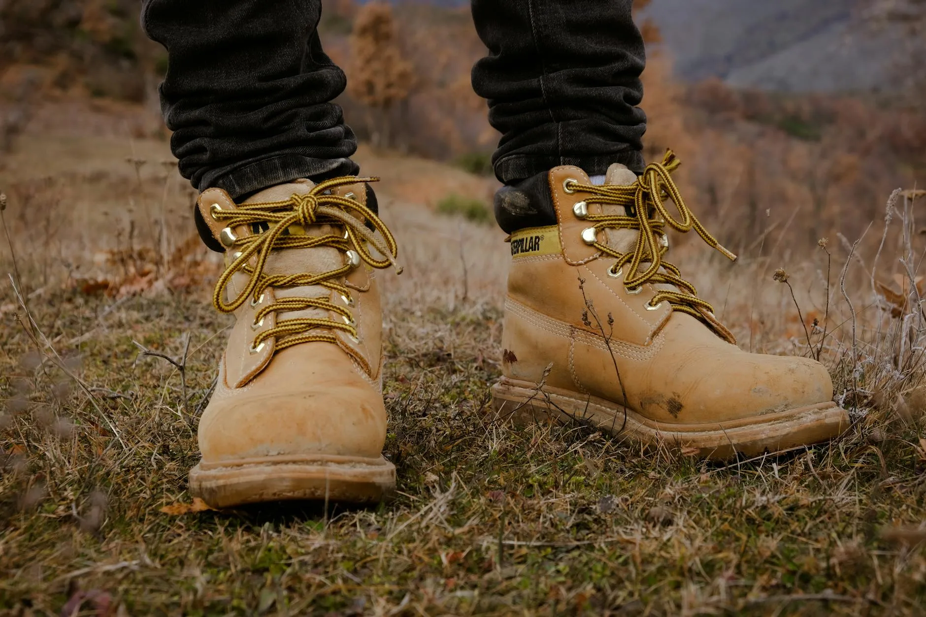 Hiking boots and trekking poles on a mountain path