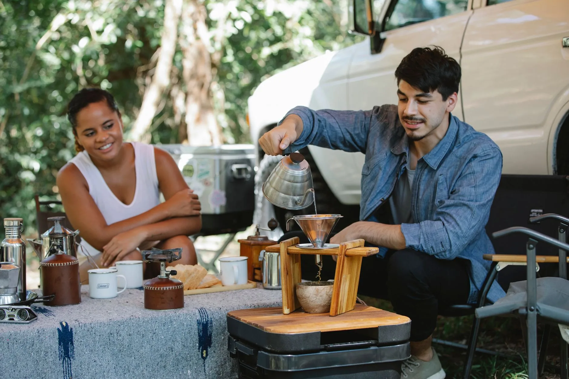 Pour-over coffee dripper set up at a campsite