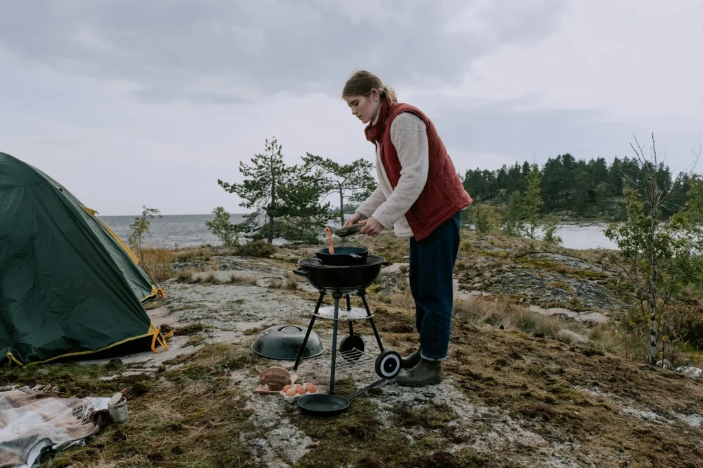 Camping cookware being cleaned outdoors at a campsite