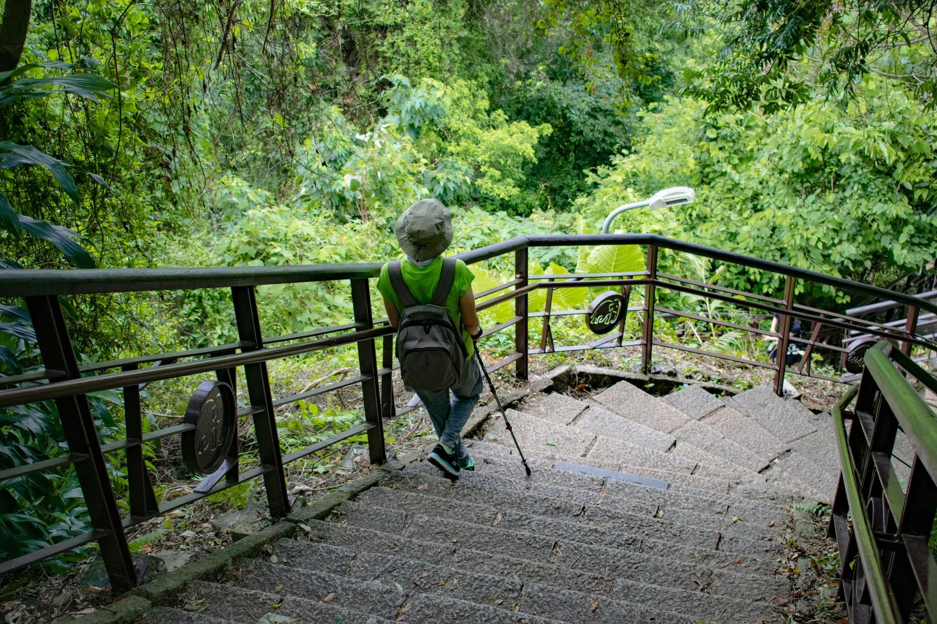 Hiker walking uphill with a backpack for training