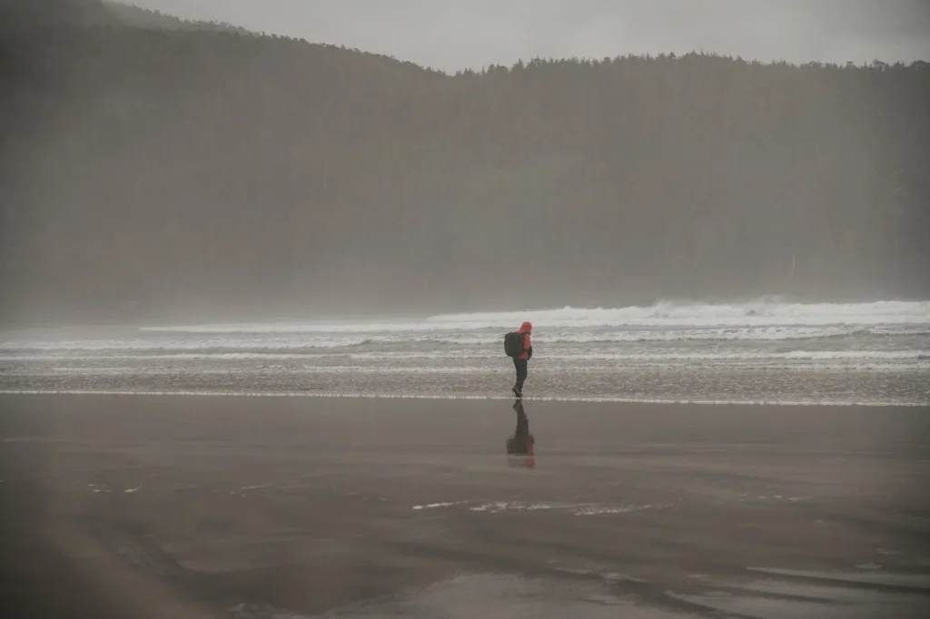 Waterproof hiking backpack with rain cover on a wet UK trail
