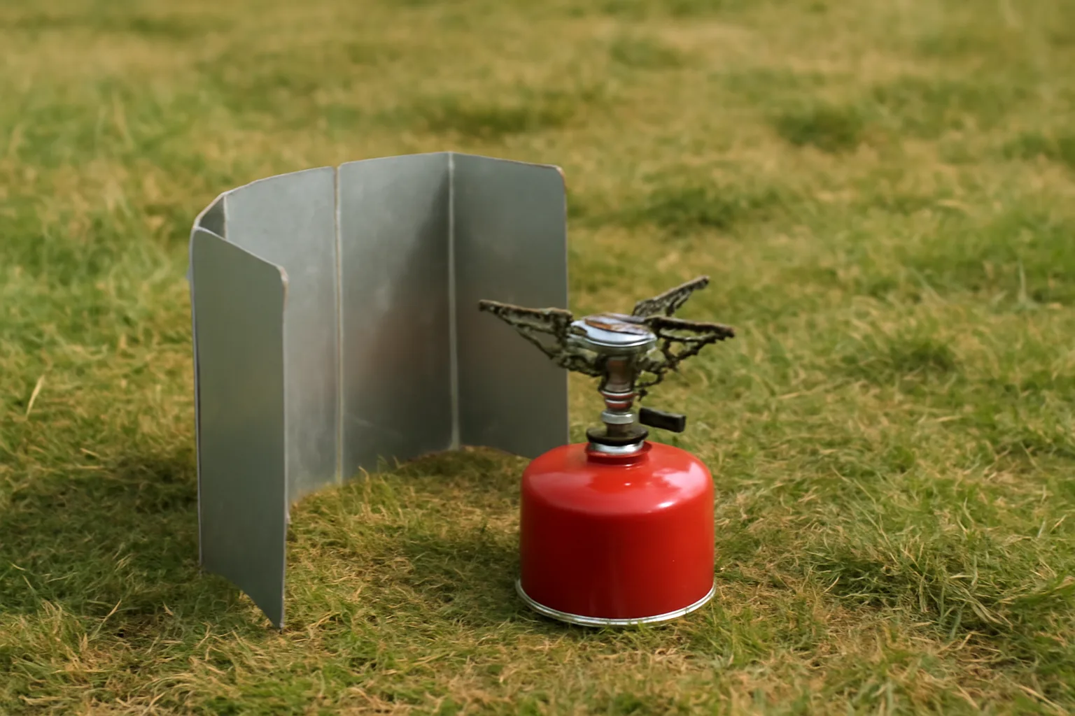 Partial camping stove wind shield with safe ventilation gap